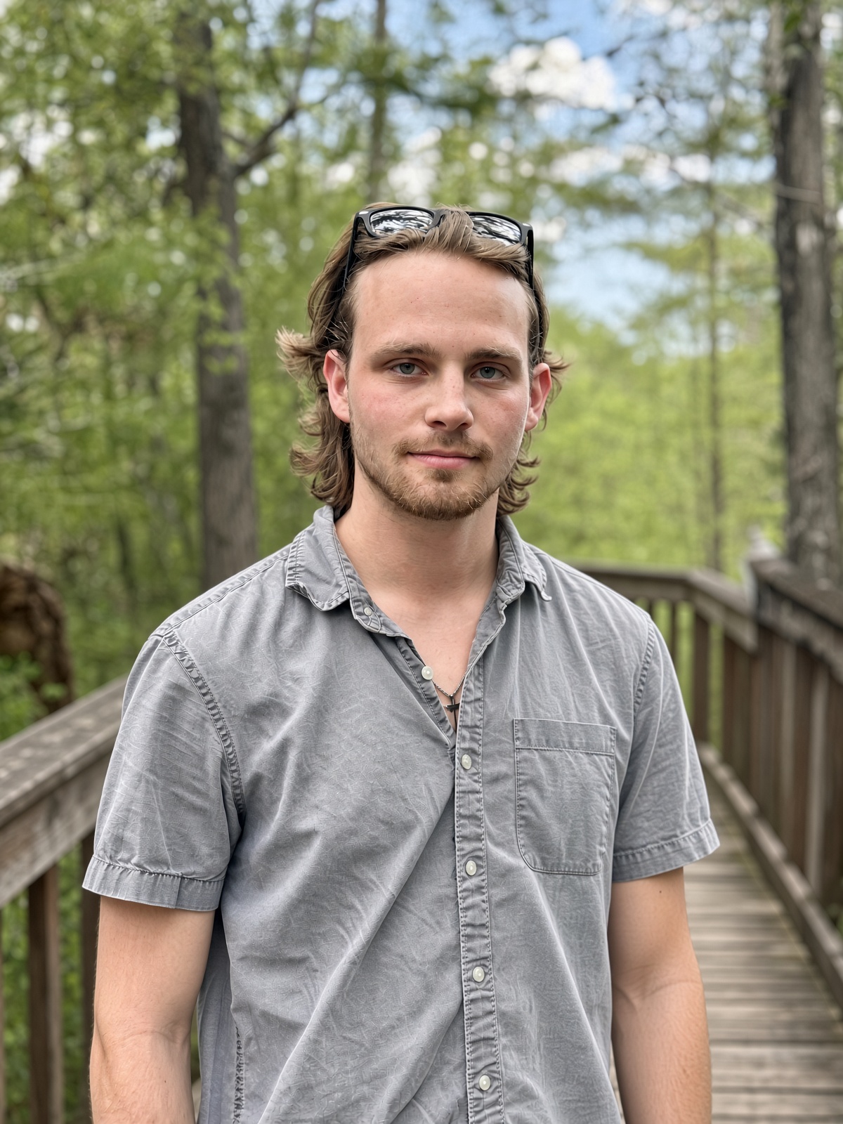 Jacob Potter, founder and photographer, standing on a wooded boardwalk